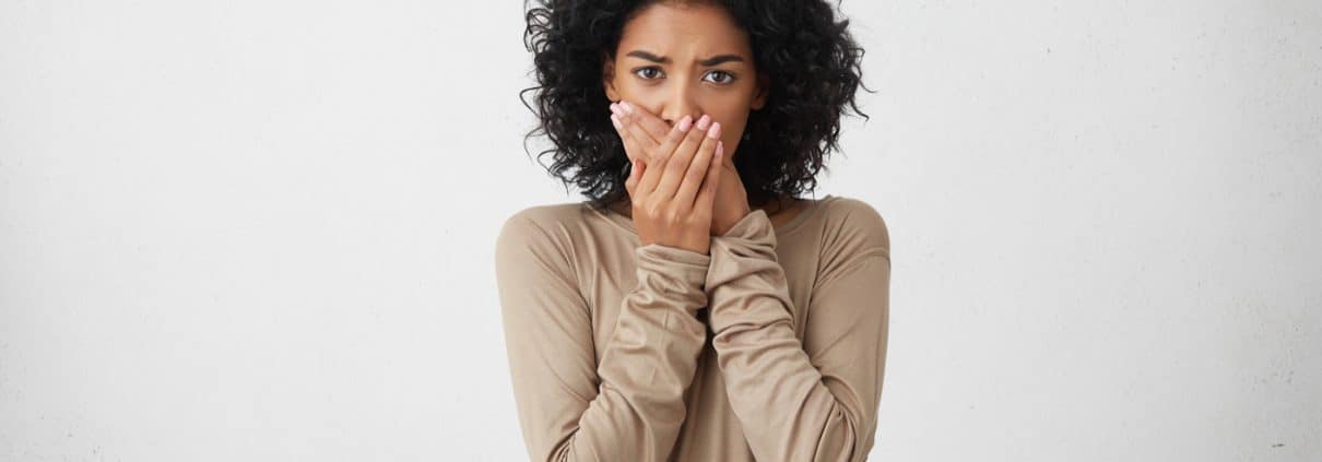 close-up-portrait-of-upset-scared-black-woman-covering-her-mouth-with-both-palms-to-prevent-screaming-sound-after-seeing-or-hearing-something-bad-negative-emotions-facial-expressions-and-feelings