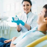 female-dentist-shows-dentures-to-little-boy