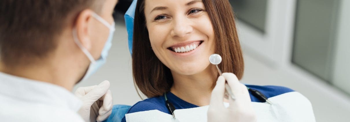 male-professional-dentist-with-gloves-mask-discuss-what-treatment-will-look-like-patient-s-teeth