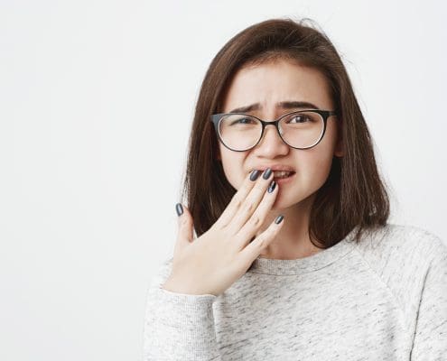 woman-covering-mouth